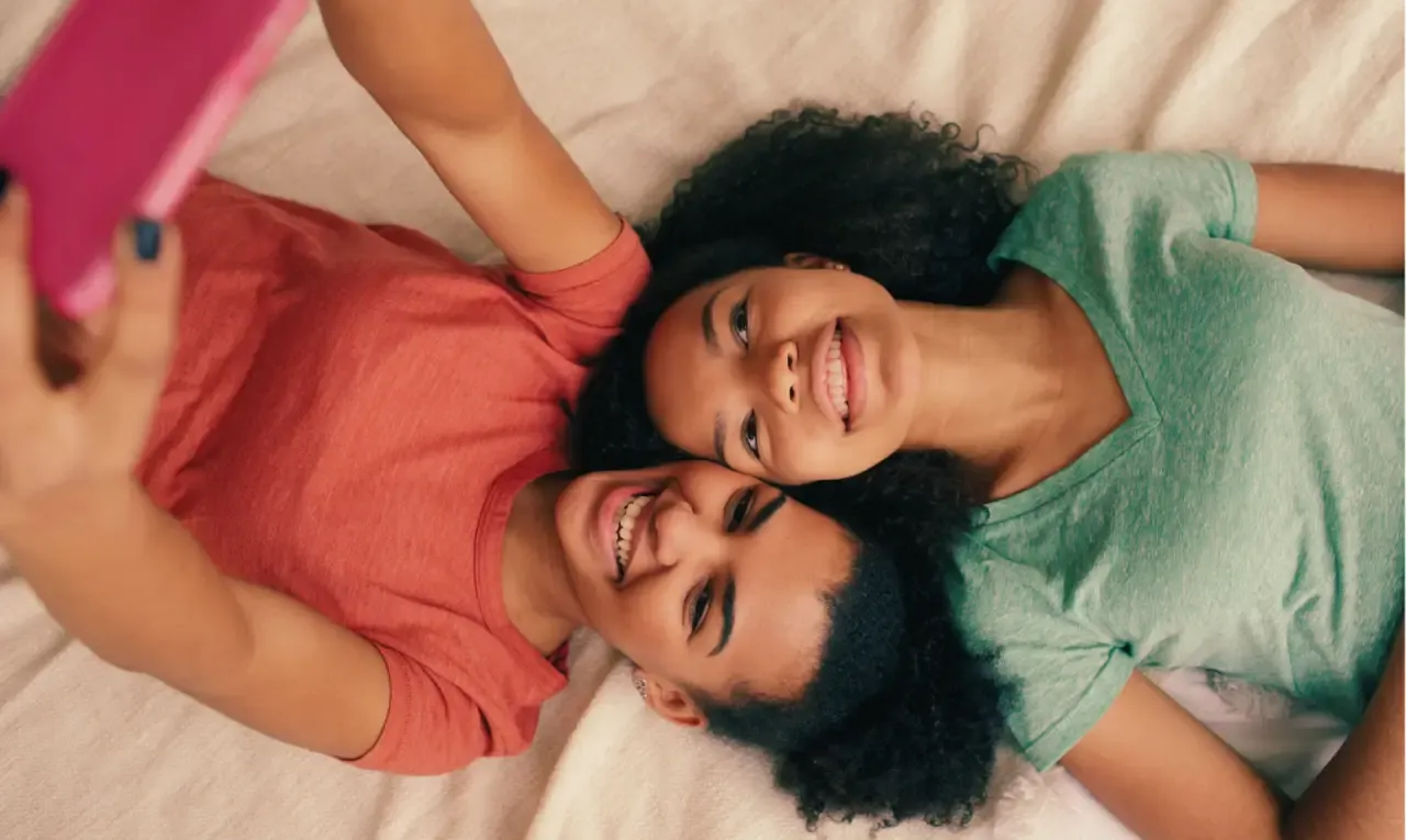 ladies enjoying internet together smiling